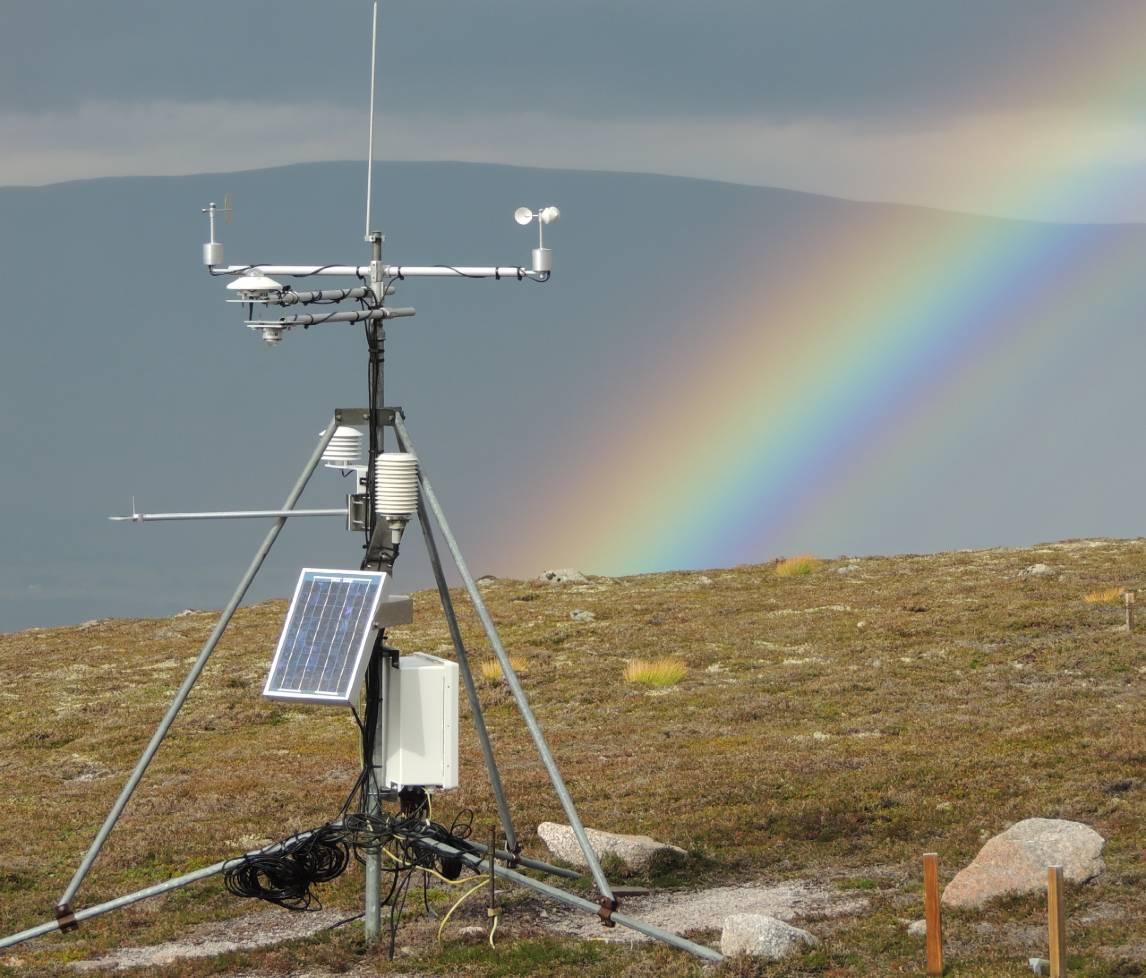 ECN field equipment with a rainbow in background